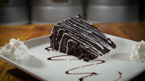Indulgent dark chocolate triple layer cake drizzled with glaze and Video stock 166614371