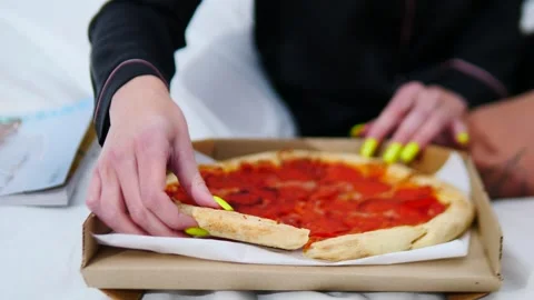 Indulging in delicious pizza while lounging in bed with my vibrant and colorful Stock Footage 307997392