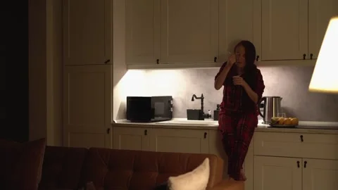 Indulging in Late Night Snacking A Womans Delightful and Relaxing Evening Meal Video stock 289967013