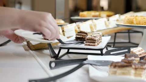 Indulging in a Selection of Delicious Pastries at a Dessert Table Stock Footage 316523932