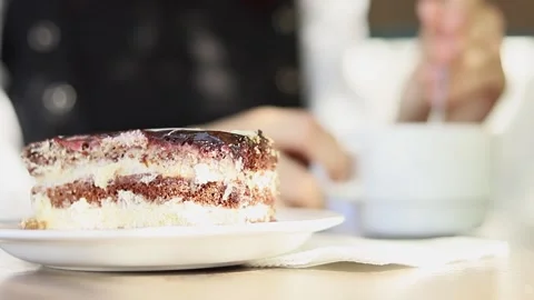 Indulging in a slice of delicious cake during a cozy coffee break Stock-Footage 295269748