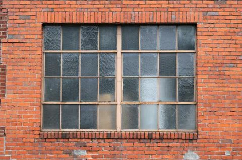 Industrail window with red cobblestone bricks Stock Photos