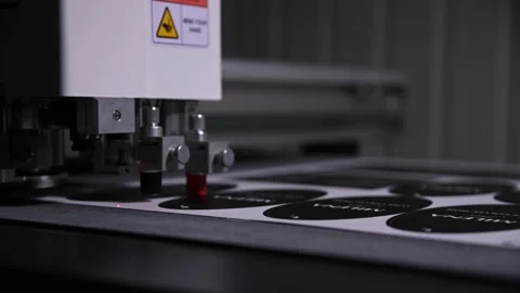 An industrial advertising plotter close-up cuts a template on the cardboard 動画素材 167583011