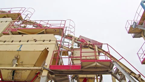Industrial aggregate processing plant with conveyor system, metal platforms, and Stock Footage 304312974