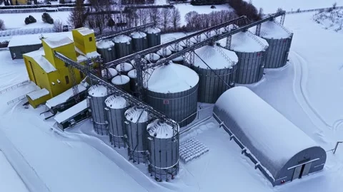 Industrial agricultural complex with grain elevators and steel silos covered in Stock Footage 334693055