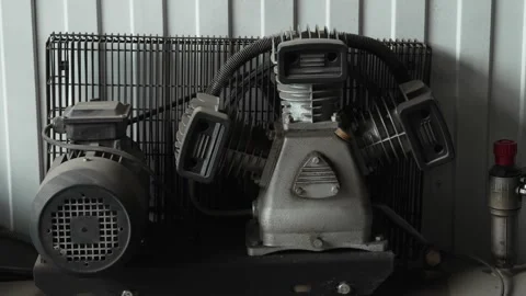 Industrial air compressor unit with electric motor inside professional workshop. Stock Footage 341487702