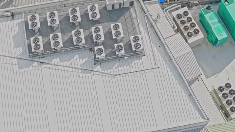 Industrial air conditioning units spin on a factory roof Stock Footage 340575177