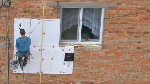 Industrial alpinism. The work on the outer Insulate of an apartment house Stock Footage 81525423