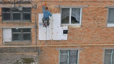 Industrial alpinism. The work on the outer Insulate of an apartment house Stock Footage 81525546