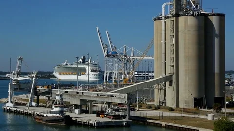 Industrial area on the coast and cruise ship in the background Stock Footage