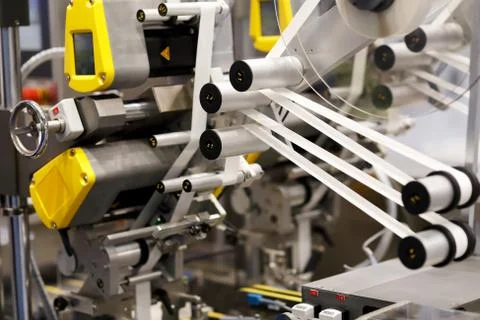 Industrial automatic labeling machine Stock Photos