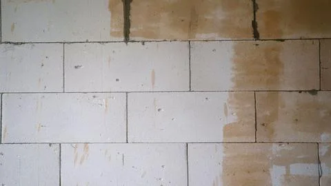 Industrial background. Structural plaster on the wall. Wall with yellow prime Stock Photos