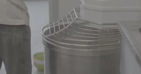 Industrial bakery worker preparing large mixer with pitcher over stainless Stock Footage 344582867