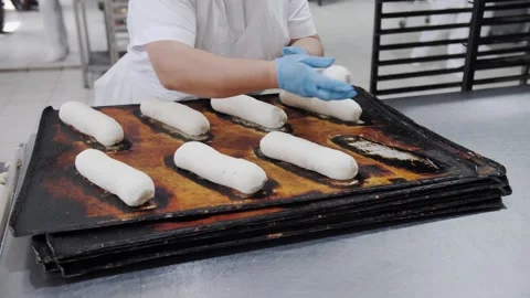 Industrial Bakery Worker Shaping Raw Bread Dough Stock Footage 321691759