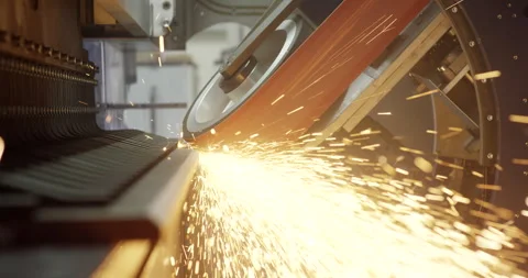 Industrial belt grinding machine processing metal part with bright sparks Stockbeeldmateriaal 329492461