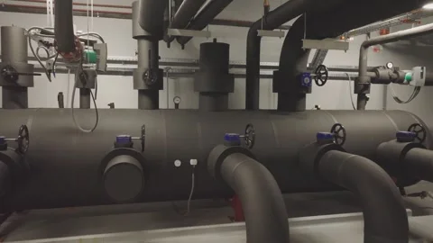 Industrial boiler room heating system with insulated pipes and valves in mo.. Stock Footage 337406874