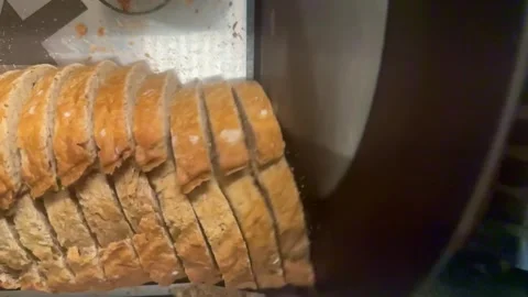 Industrial bread slicing machine in action Stock Footage 338309445