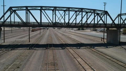 Industrial bridge and empty train tracks - drone low shot Stock Footage 107879962
