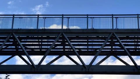 An industrial bridge structure dramatically positioned against a vibrant bl.. Foto stock