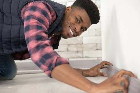 Industrial builder worker installing floor Stock Photos