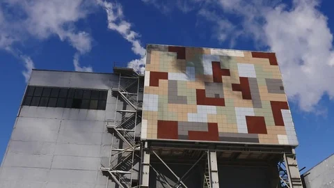 Industrial building with colored elements, blue sky and industrial smoke Stock Footage 73949094