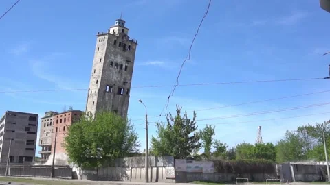 An industrial building explodes in controlled demolition on a sunny day.Highly Stock Footage 164905442