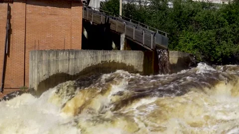 Industrial building made of red brick with wooden water gutter on the shore Stock Footage 139472001