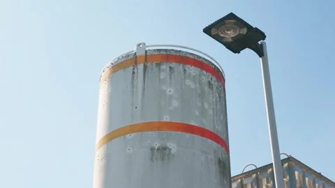 Industrial Bulk Storage Silo Tank with Orange Safety Stripes Stock Footage 345852636