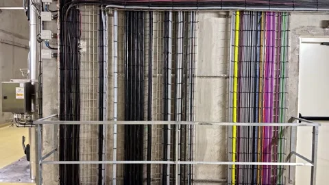 Industrial Cable Tray with Color-Coded Wire Bundles on Concrete Wall in Modern 库存影片 333776682