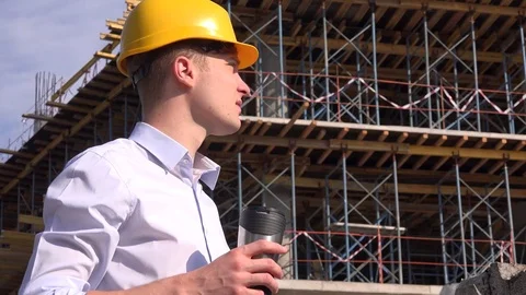 Industrial career young engineer drinking coffee break worker use helmet hardhat Stock Footage