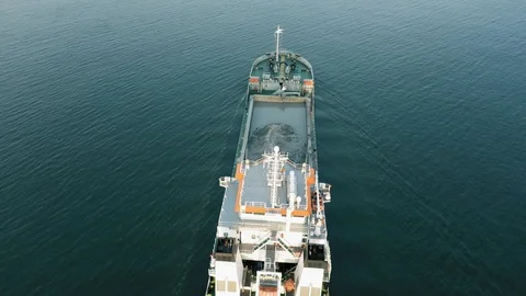 Industrial cargo freighter ship leaving port, top down aerial view Stock Footage 111503494