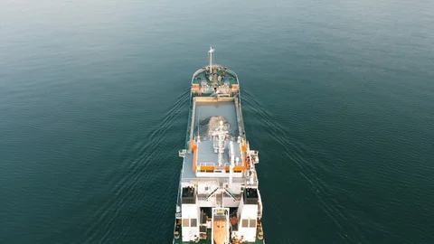 Industrial cargo freighter ship leaving port, top down aerial view Stock Footage 111503596