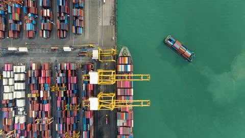 Industrial Cargo Ship Loading Containers At Busy International Port Termina.. Stock Photos