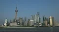 Industrial Cargo Ship Passing on Huangpu River with Shanghai City Pudong Skyline HD Footage