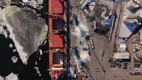 Industrial cargo unloading operation in icy harbor Stock Footage 329452368
