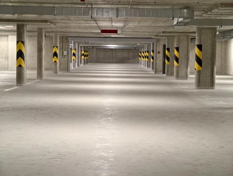 Industrial cavern solitude, open subterranean lot featuring repeating support Stock Photos