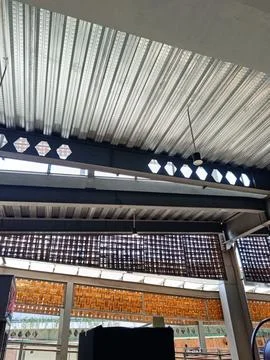 Industrial Ceiling With Brick Patterns and Modern Lighting Stock Photos