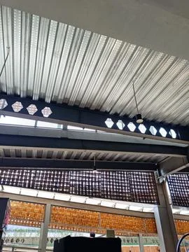 Industrial Ceiling With Brick Patterns and Modern Lighting Stock Photos