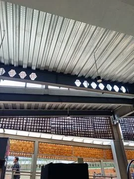 Industrial Ceiling With Brick Patterns and Modern Lighting Stock Photos