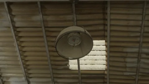 Industrial ceiling lamp in a rustic warehouse Stock-Footage 335732365
