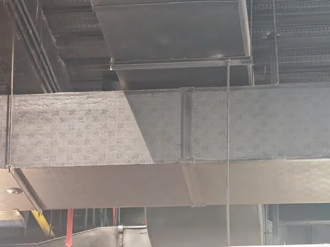 Industrial Ceiling Structure with Textured Wall and Shadow Stock Photos