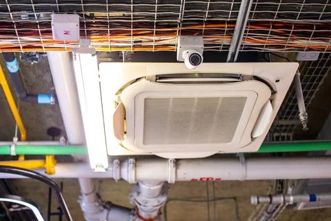 Industrial ceiling utility installation with electrical wire trays, air con.. Stock Photos