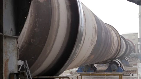 An industrial cement processing facility. Rotating furnace equipment at the Stock Footage 156389266