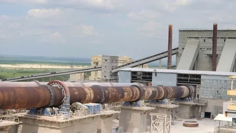 An industrial cement processing facility. Rotating furnace equipment at the Stock Footage 156389982