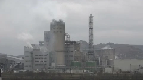 Industrial chimneys with heavy smoke causing air pollution on gray sky backgroun Stock Footage 171704591