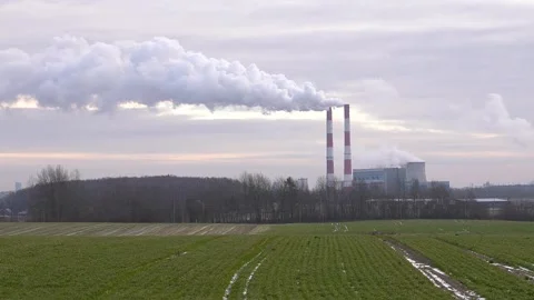 Industrial chimneys with heavy smoke causing air pollution on the gray sky backg Stock Footage 295436016