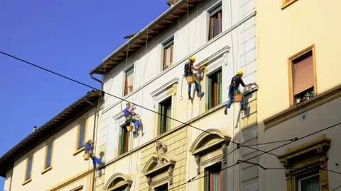 Industrial climber at height paint the facade Stock Footage 149082186