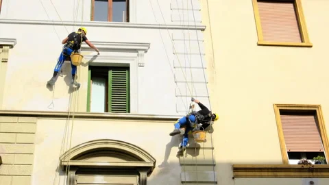 Industrial climber at height paint the facade Stock Footage 149083889