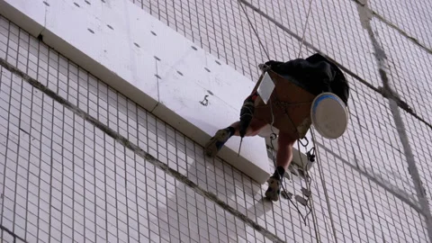 Industrial Climber Insulation of Facade Old High-Rise Building Using Styrofoam Stock Footage 130747669