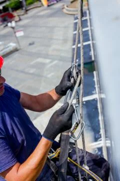 Industrial climber is prepare, adjust his ropes Stock Photos